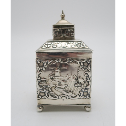 2493 - A DUTCH EXPORT SILVER TEA CADDYof cuboid form, the body with repousse and chased decoration of rural... 