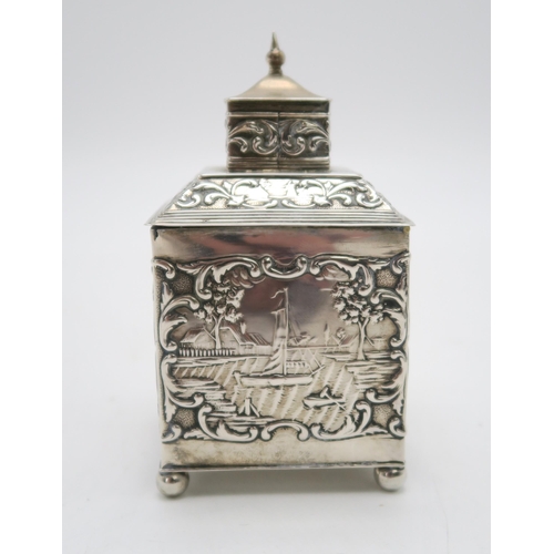 2493 - A DUTCH EXPORT SILVER TEA CADDYof cuboid form, the body with repousse and chased decoration of rural... 