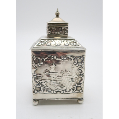 2493 - A DUTCH EXPORT SILVER TEA CADDYof cuboid form, the body with repousse and chased decoration of rural... 