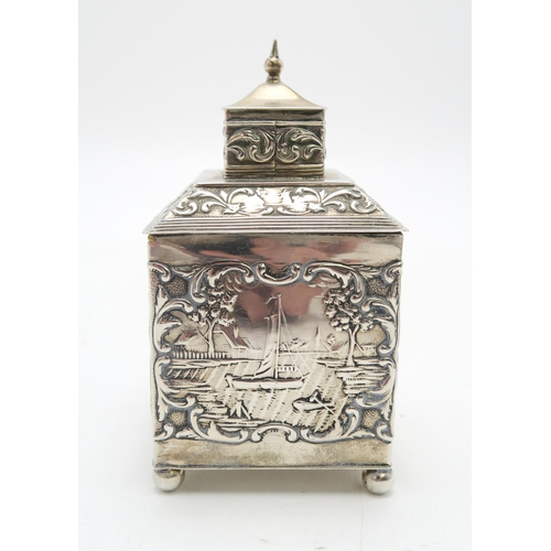 2493 - A DUTCH EXPORT SILVER TEA CADDYof cuboid form, the body with repousse and chased decoration of rural... 