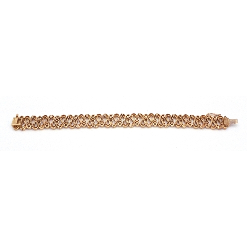 2701 - A 9CT GOLD WAVE PATTERN BRACELETinterspaced with sparkling cubic zirconia, length of the bracelet 18... 