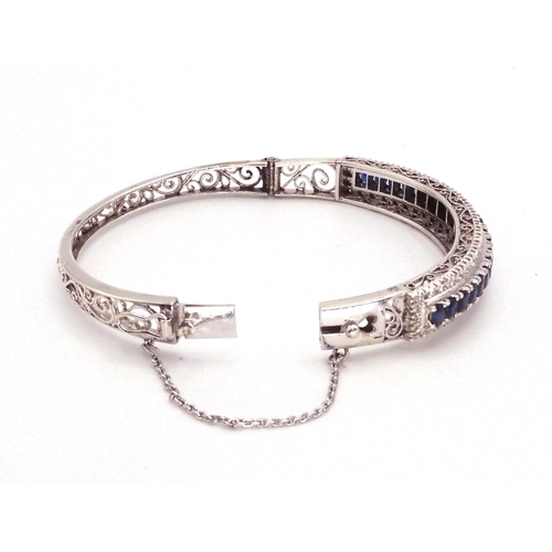 2702 - A SAPPHIRE AND DIAMOND BRACELET in 18k white gold set with twenty one oval sapphires tapering i... 