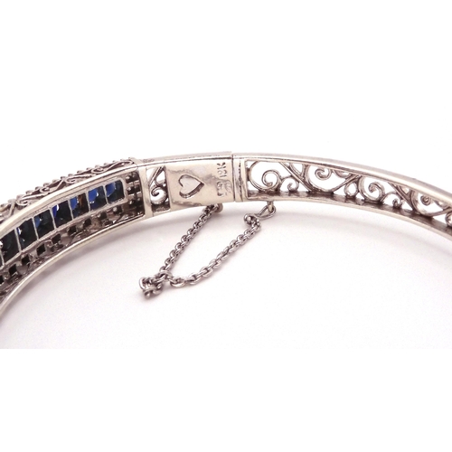 2702 - A SAPPHIRE AND DIAMOND BRACELET in 18k white gold set with twenty one oval sapphires tapering i... 