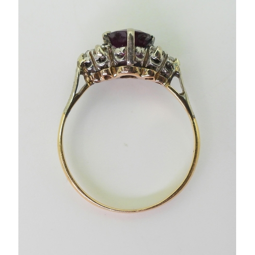 2703 - A VINTAGE RINGset with diamonds and a faux purple sapphire, mounted in bright yellow and white metal... 