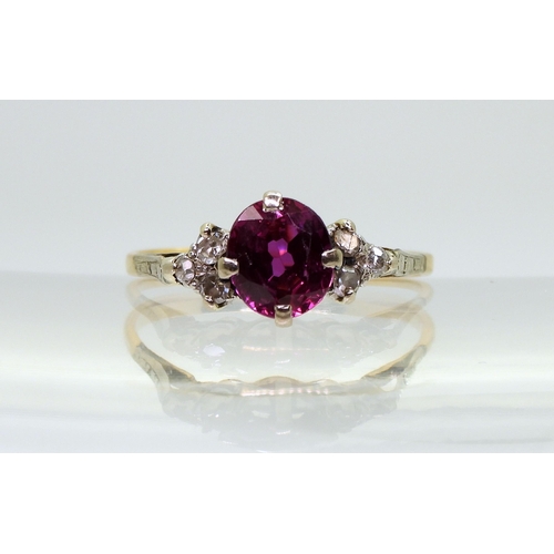 2703 - A VINTAGE RINGset with diamonds and a faux purple sapphire, mounted in bright yellow and white metal... 