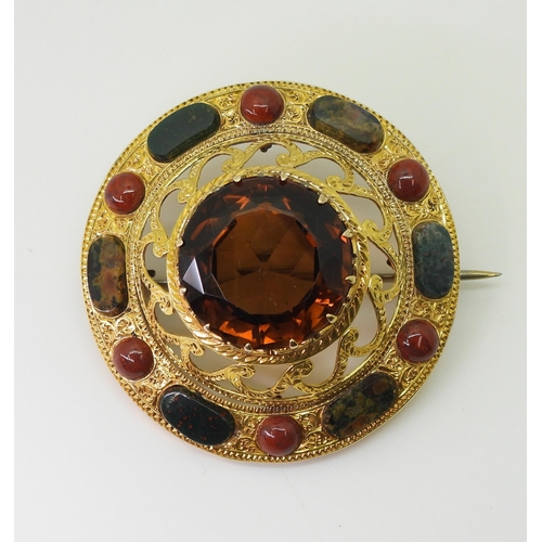 2705 - A SCOTTISH AGATE BROOCHthe bright yellow metal mount is extensively engraved with swags and a zig za... 