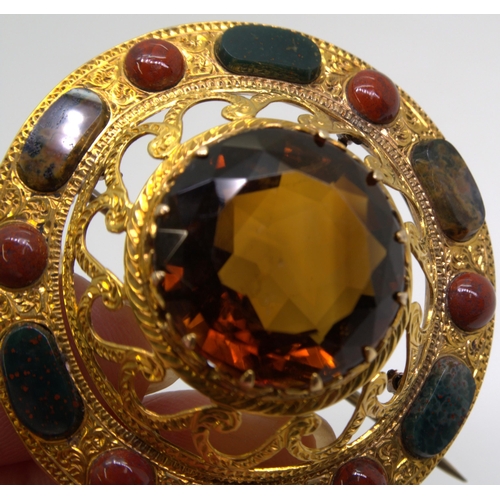 2705 - A SCOTTISH AGATE BROOCHthe bright yellow metal mount is extensively engraved with swags and a zig za... 