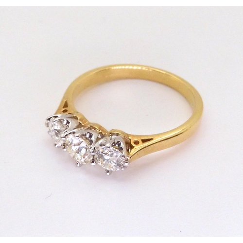 2707 - A CLASSIC THREE STONE DIAMOND RINGthe 18ct yellow and white gold mount set with estimated approx 1ct... 