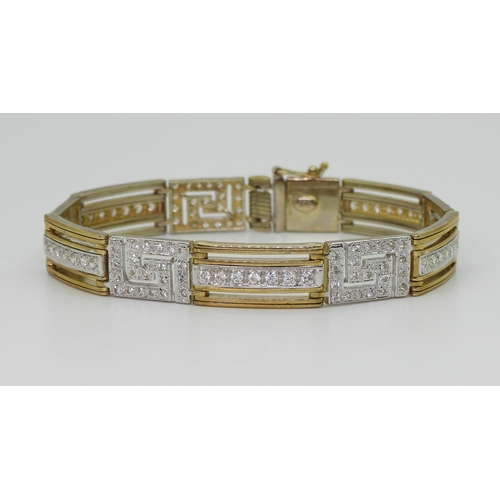 2713 - A 9CT GOLD KEY PATTERN BRACELETin yellow gold with the key patterns and bars set with sparkling cubi... 