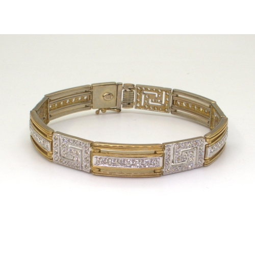 2713 - A 9CT GOLD KEY PATTERN BRACELETin yellow gold with the key patterns and bars set with sparkling cubi... 