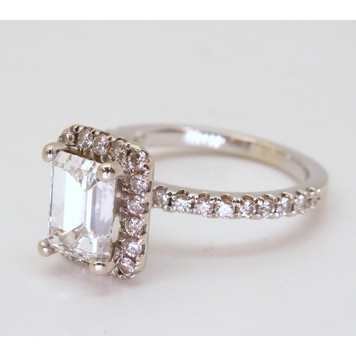 2714 - A 14K WHITE GOLD SUBSTANTIAL DIAMOND RINGset with an estimated approx 1.40ct step cut diamond, with ... 