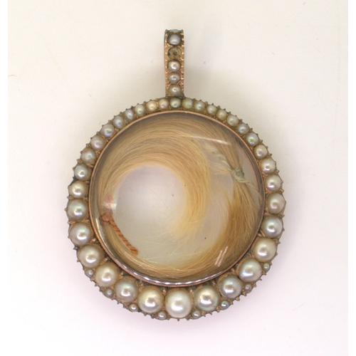 2720 - A VICTORIAN PEARL SET LOCKETthe rose-coloured mount with double sided glazed panel containing two lo... 