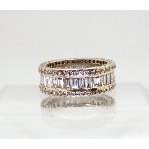 2723 - A FULL DIAMOND ETERNITY RINGmounted throughout in 18ct white gold. Centrally set with baguette diamo... 