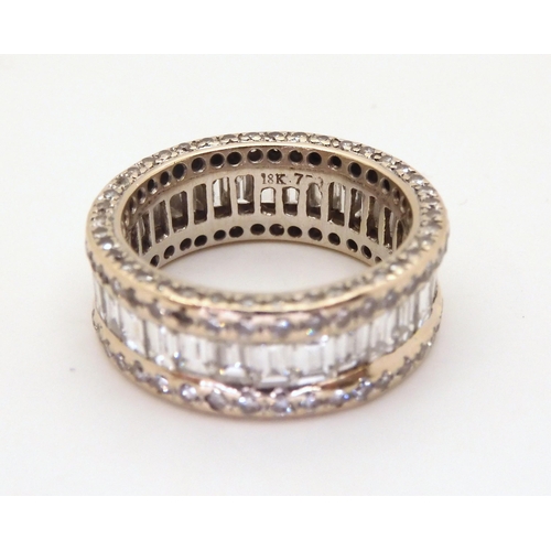 2723 - A FULL DIAMOND ETERNITY RINGmounted throughout in 18ct white gold. Centrally set with baguette diamo... 