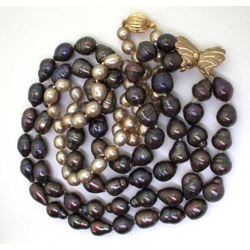 2733 - TWO GOOD STRINGS OF PEARLSa double string of black baroque pearls with a 9ct gold butterfly shaped c... 