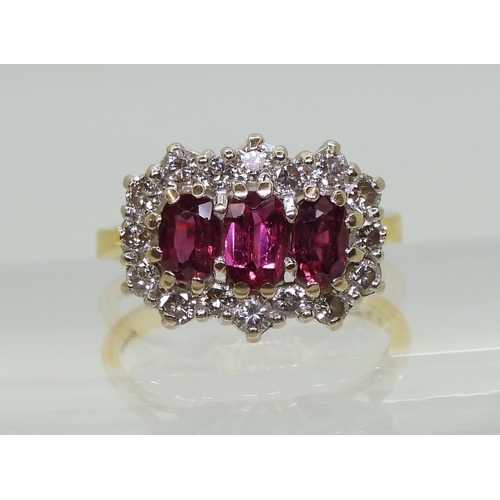 2738 - A RUBY AND DIAMOND RING18ct gold set with three rubies, largest approx. 6mm x 3.7mm x 2.6mm, smaller... 