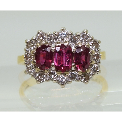 2738 - A RUBY AND DIAMOND RING18ct gold set with three rubies, largest approx. 6mm x 3.7mm x 2.6mm, smaller... 