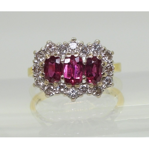 2738 - A RUBY AND DIAMOND RING18ct gold set with three rubies, largest approx. 6mm x 3.7mm x 2.6mm, smaller... 