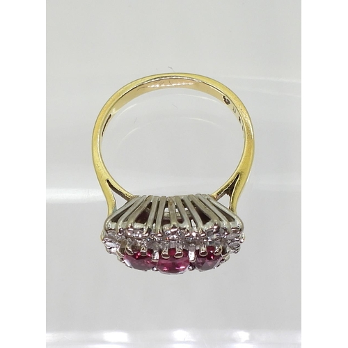 2738 - A RUBY AND DIAMOND RING18ct gold set with three rubies, largest approx. 6mm x 3.7mm x 2.6mm, smaller... 