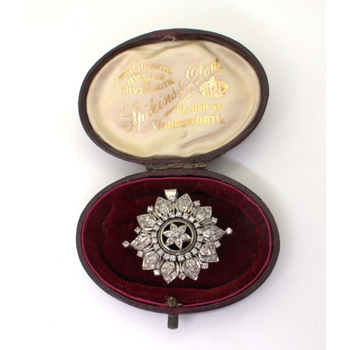 2742 - A VICTORIAN PENDANT BROOCHthe diamond flower, is set with old cut diamonds to the white metal handma... 