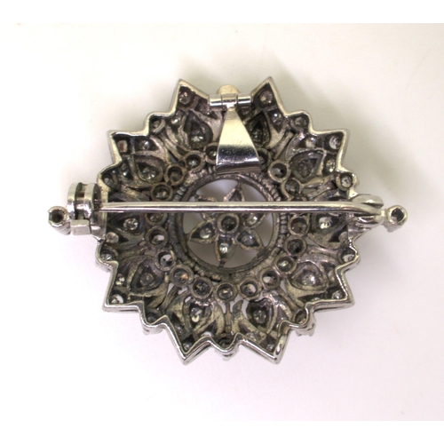 2742 - A VICTORIAN PENDANT BROOCHthe diamond flower, is set with old cut diamonds to the white metal handma... 