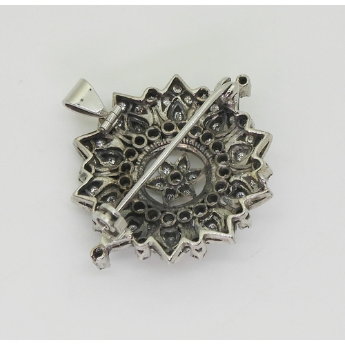 2742 - A VICTORIAN PENDANT BROOCHthe diamond flower, is set with old cut diamonds to the white metal handma... 