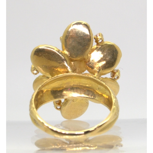 2744 - A VINTAGE STATEMENT RINGthe large multi-petal flower is made in 18ct gold with London hallmarks for ... 