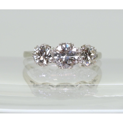 2747 - A CLASSIC THREE STONE DIAMOND RINGthe white metal shank stamped 750. with the three diamonds set int... 