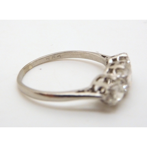 2747 - A CLASSIC THREE STONE DIAMOND RINGthe white metal shank stamped 750. with the three diamonds set int... 