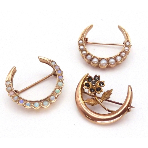 2757 - THREE CRESCENT MOON BROOCHESa 9ct gold opal set brooch, diameter 2.4cm, a 9ct split pearl moon brooc... 