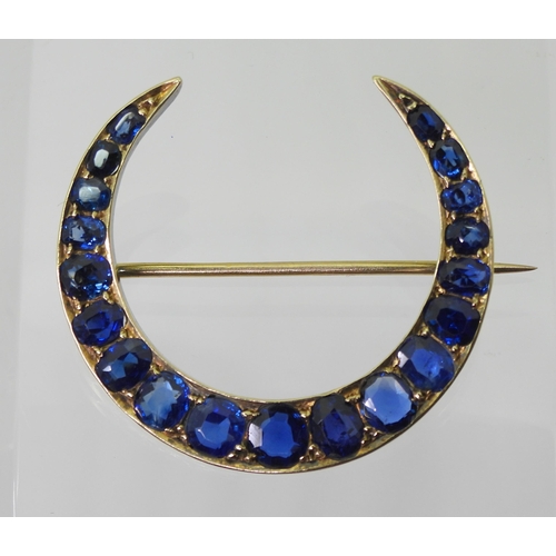 2759 - A CRESCENT MOON BROOCHset with sapphires to the galleried mount. Largest sapphire approx 5mm x 4.6mm... 