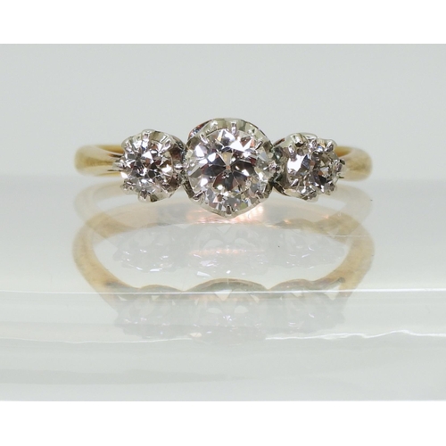 2761 - A THREE STONE DIAMOND RINGthe 18ct yellow and white gold mount is set with three old cut diamonds wi... 