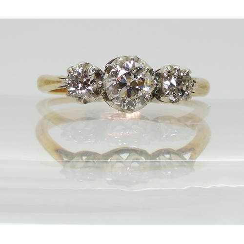 2761 - A THREE STONE DIAMOND RINGthe 18ct yellow and white gold mount is set with three old cut diamonds wi... 