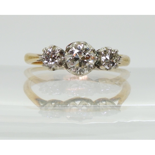 2761 - A THREE STONE DIAMOND RINGthe 18ct yellow and white gold mount is set with three old cut diamonds wi... 