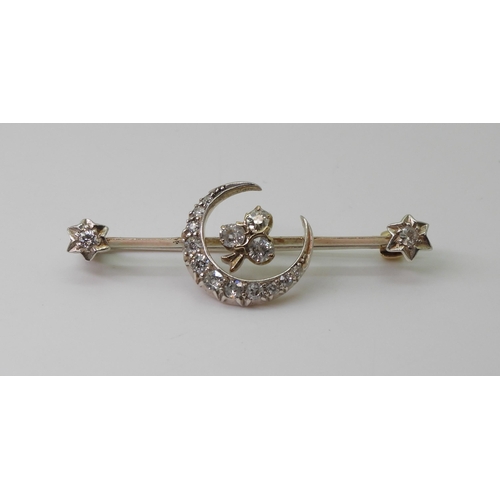 2766 - A DIAMOND CRESCENT MOON BROOCHthe white metal mount is set with estimated approx 0.50cts of old cut ... 