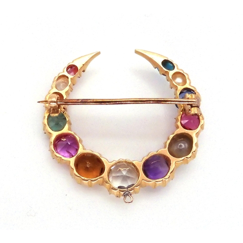 2769 - A GEM SET CRESCENT MOON BROOCHset with gem specimens to include, cats eye chrysoberyl, amethyst, sap... 