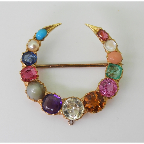 2769 - A GEM SET CRESCENT MOON BROOCHset with gem specimens to include, cats eye chrysoberyl, amethyst, sap... 