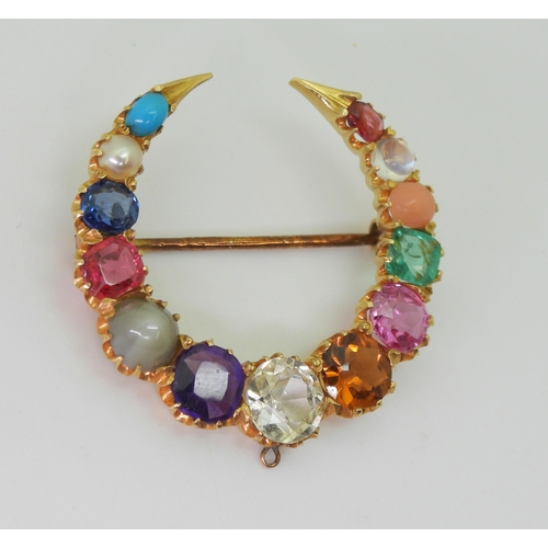 2769 - A GEM SET CRESCENT MOON BROOCHset with gem specimens to include, cats eye chrysoberyl, amethyst, sap... 