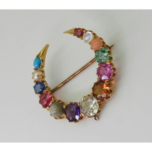 2769 - A GEM SET CRESCENT MOON BROOCHset with gem specimens to include, cats eye chrysoberyl, amethyst, sap... 