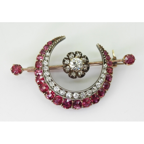 2835 - A SUBSTANTIAL CRESCENT MOON BROOCHset with diamonds and rubies to the crescent, central flower and t... 