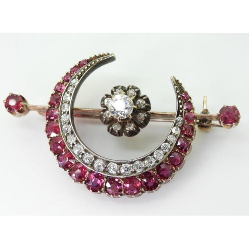 2835 - A SUBSTANTIAL CRESCENT MOON BROOCHset with diamonds and rubies to the crescent, central flower and t... 