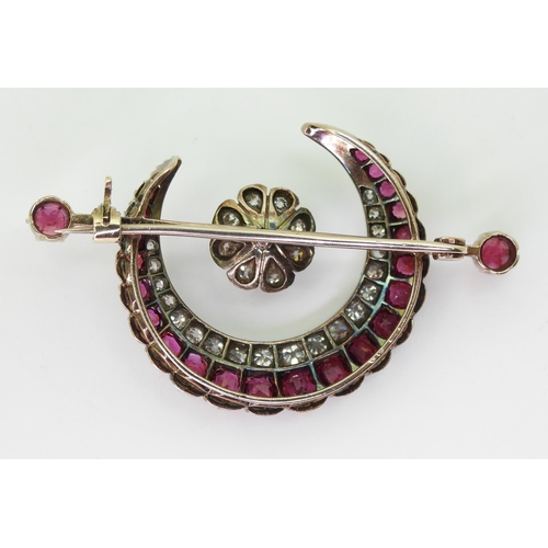 2835 - A SUBSTANTIAL CRESCENT MOON BROOCHset with diamonds and rubies to the crescent, central flower and t... 