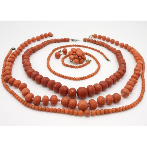 2837 - A COLLECTION OF CORAL JEWELSto include a string of faceted coral beads, the largest 14.5mm x 12.1mm,... 