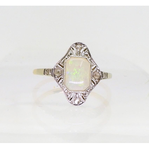 2840 - AN 18CT OPAL AND DIAMOND RINGset with a mixed cut opal with rose cut diamonds set to the pierced bez... 