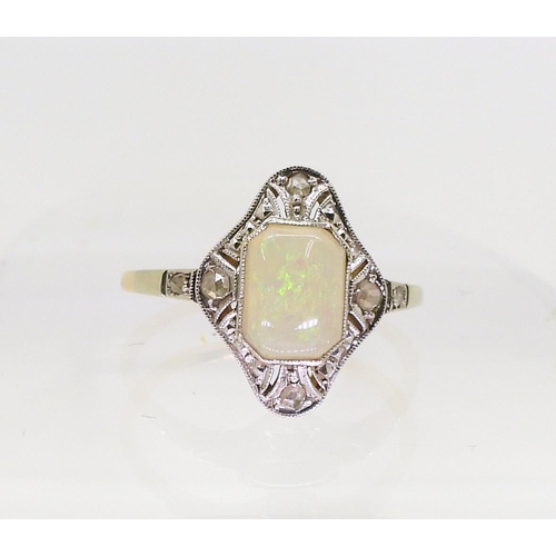 2840 - AN 18CT OPAL AND DIAMOND RINGset with a mixed cut opal with rose cut diamonds set to the pierced bez... 