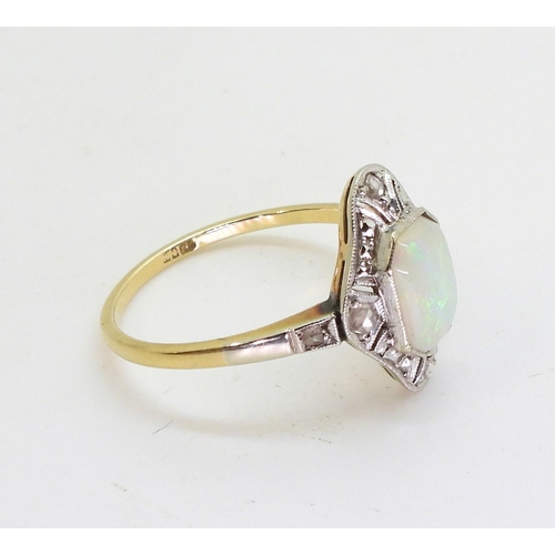 2840 - AN 18CT OPAL AND DIAMOND RINGset with a mixed cut opal with rose cut diamonds set to the pierced bez... 