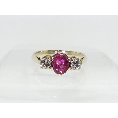 2841 - A PINK SAPPHIRE AND DIAMOND RINGmounted in white metal with decorative crown mounts, the two diamond... 