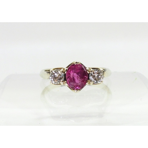 2841 - A PINK SAPPHIRE AND DIAMOND RINGmounted in white metal with decorative crown mounts, the two diamond... 