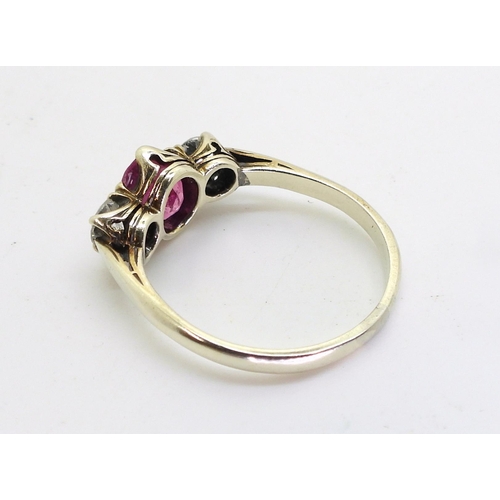 2841 - A PINK SAPPHIRE AND DIAMOND RINGmounted in white metal with decorative crown mounts, the two diamond... 