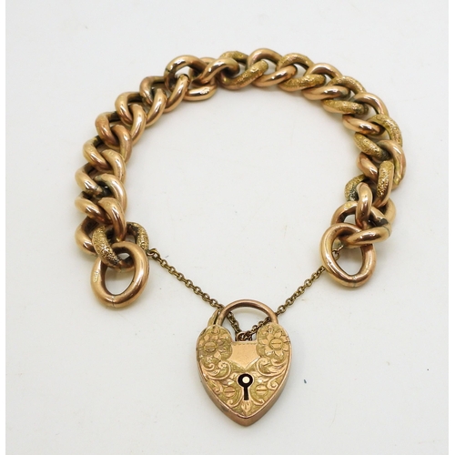 2843 - A 9CT CURB CHAIN BRACELETwith flower engraved heart shaped clasp, and with engraved texture  to ever... 